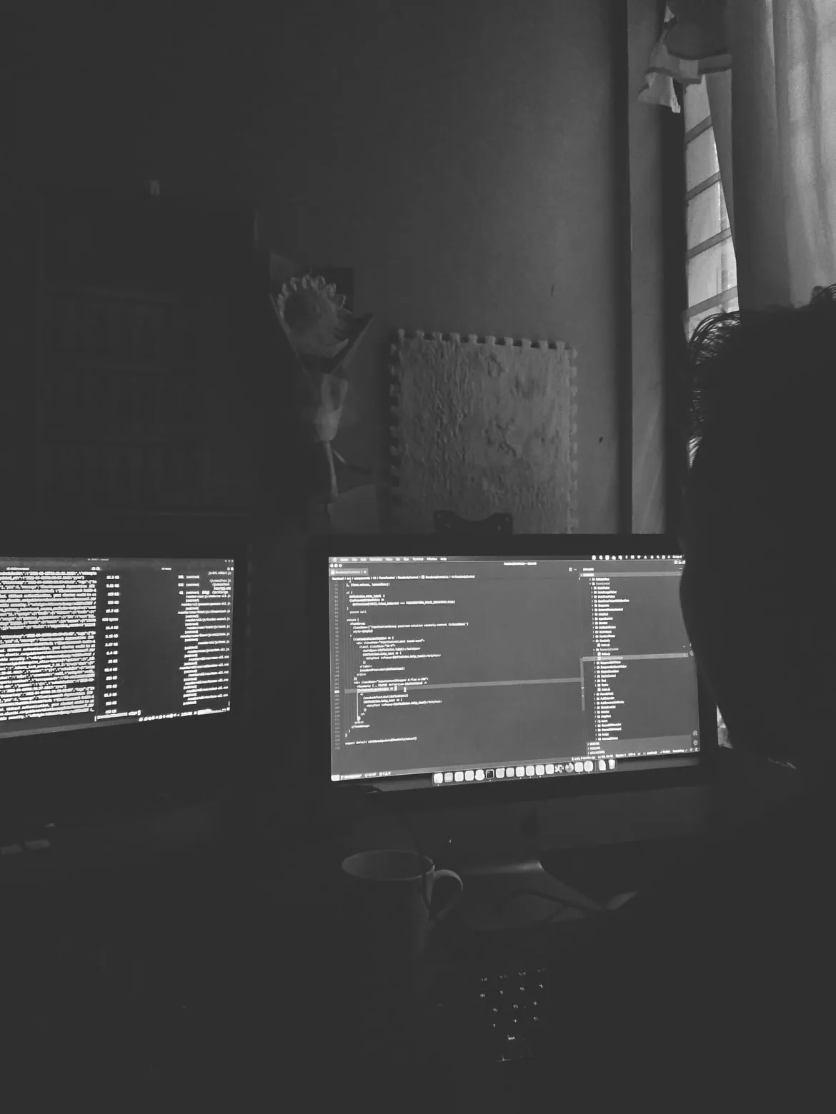 A picture of Joshua Chu in front of his work station.